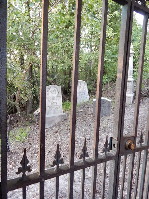 Haunted Mansion Standby Queue tombstones behind bars