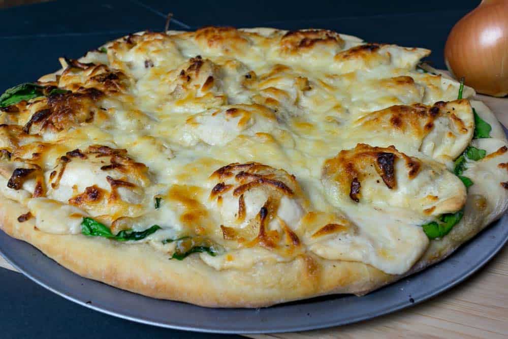 Let cheesy pierogi pizza sit for about five minutes before cutting.