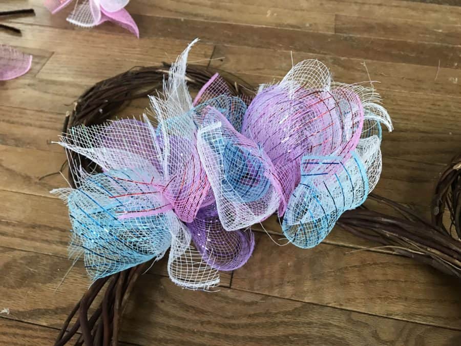 Minnie DIY Disney Easter Wreath: Add mesh ribbon bundles to wreath frame.