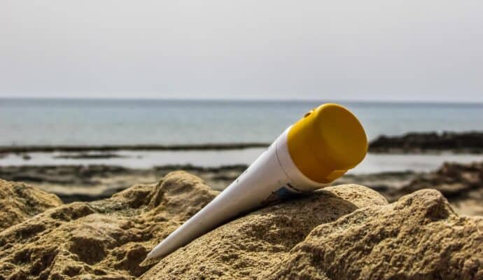 6-tips-for-wearing-sunscreen-bottle-in-sand
