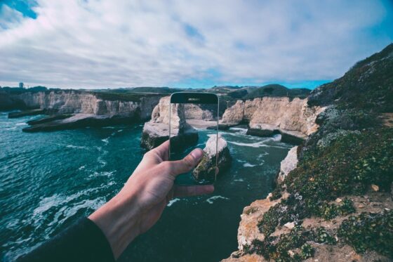 Tips to Plan a Memorable Vacation Without Stress how to prepare your phone for a long vaca - photo of phone and cliff