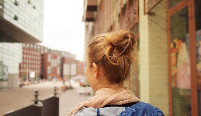 travel on a student budget - girl with hair bun