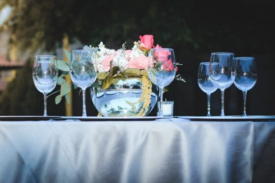 6 Practical Tips for Organizing a Great Event - empty wine glasses and flowers