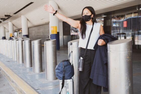 Traveling with Allergies- pack light - airport hailing a taxi