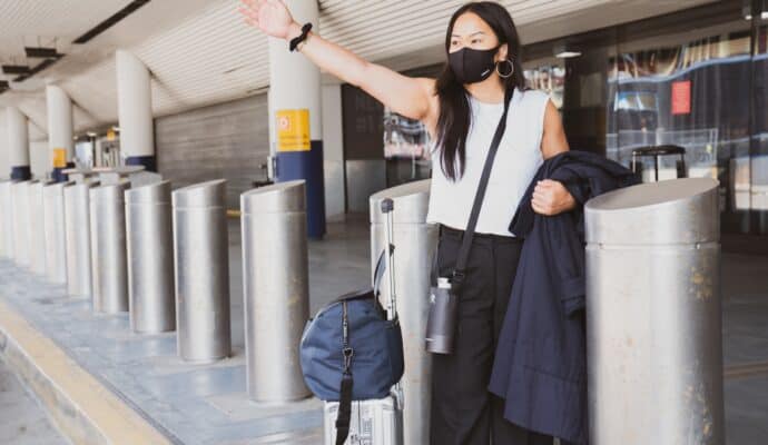 Traveling with Allergies- pack light - airport hailing a taxi