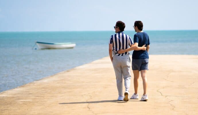 Why Are Couples’ Getaways Important for Relationships -  Male couple walking near water