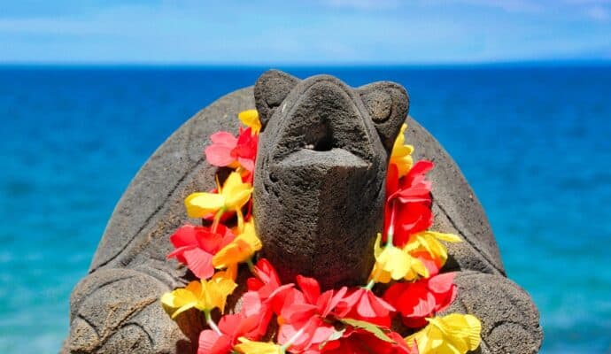 Fun Hawaiian Cultural Traditions - lei on stone turtle