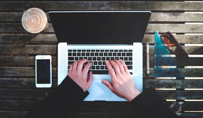 is costco travel worth it? woman at laptop researching travel