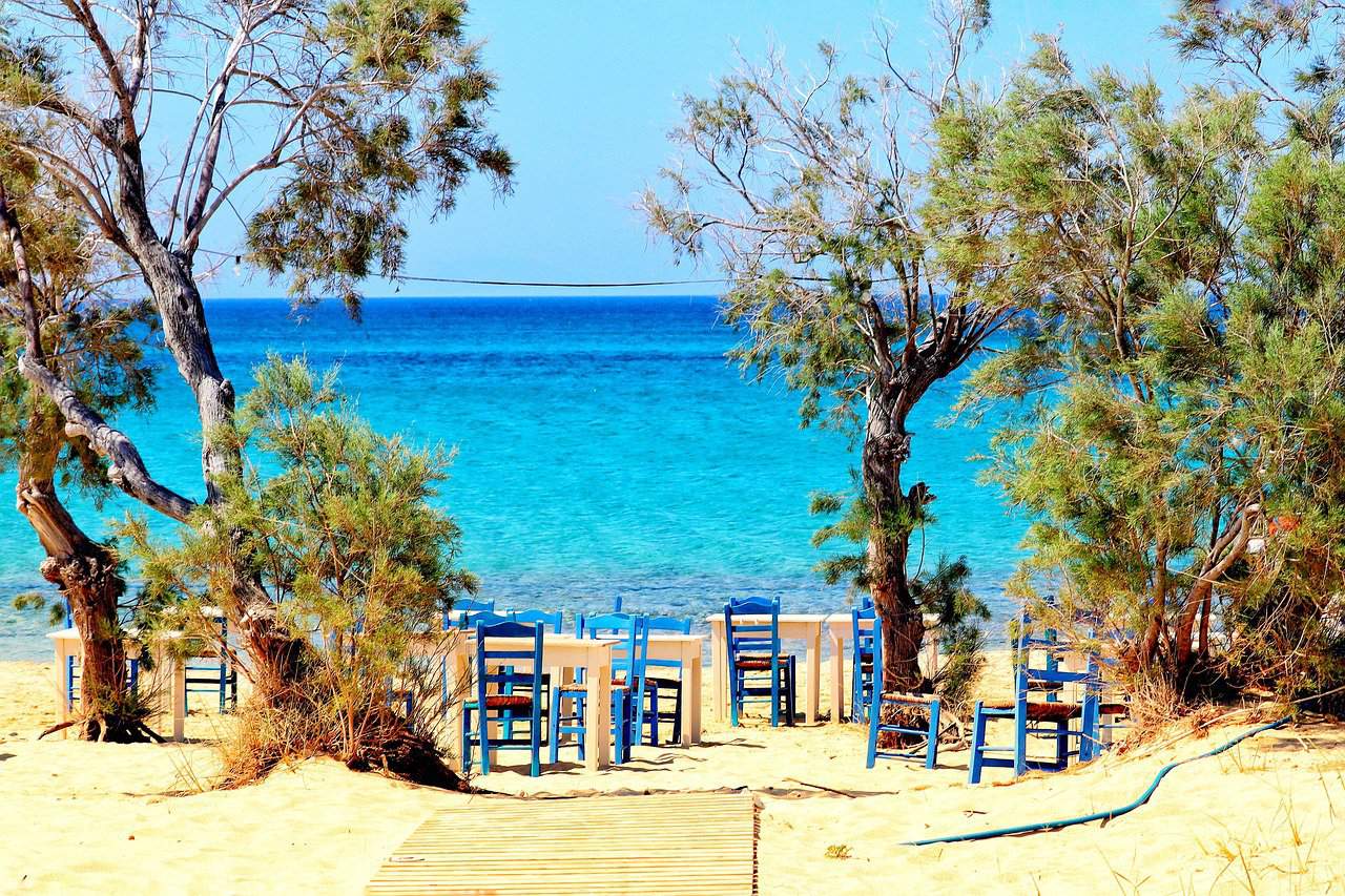 Underrated and Affordable European Destinations - naxos greece beach with chairs