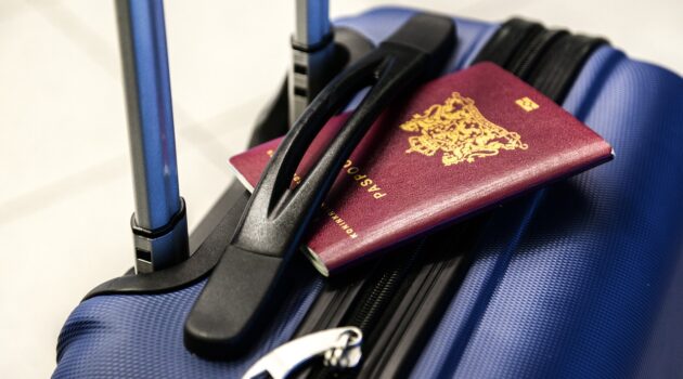 Homepage 2 Travel essentials for 2024 - suitcase with passport