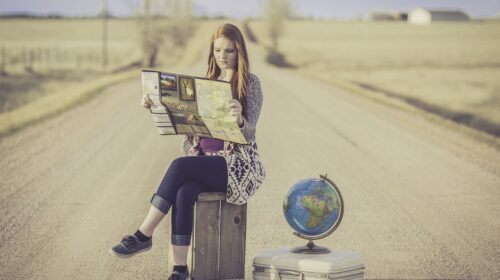 10 Big Travel Trends That Will Fade with Generation X - girl with globe and map