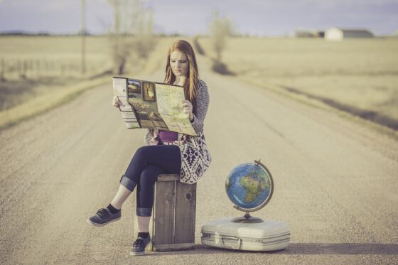 10 Big Travel Trends That Will Fade with Generation X - girl with globe and map