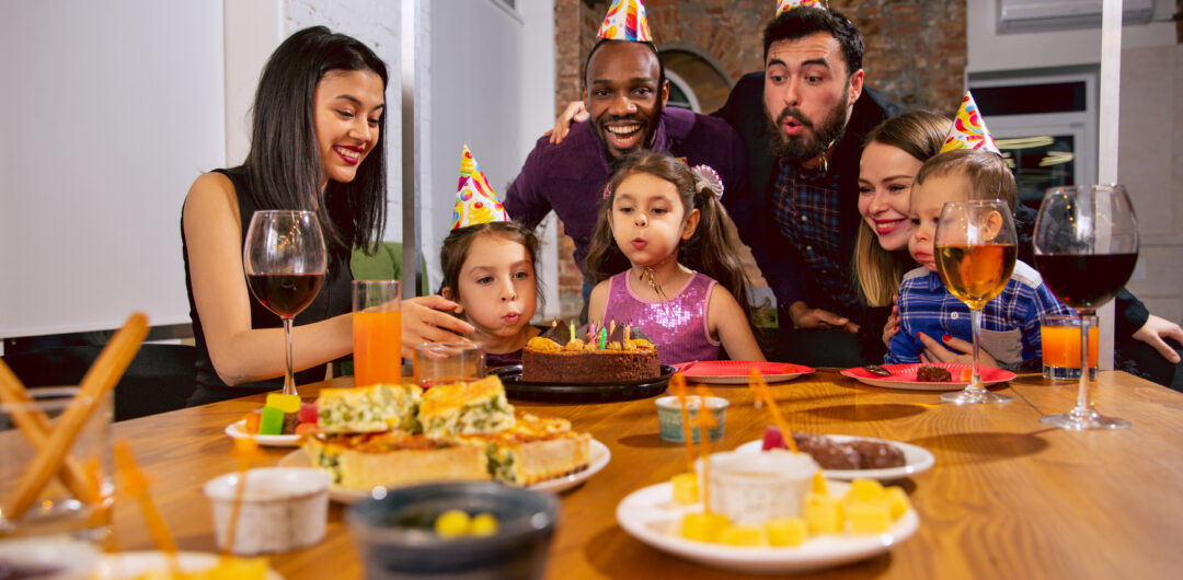 Planning a Surprise Party? Here’s What You Really Need to Think About 1 planning a surprise party - working abroad - Portrait of happy family celebrating a birthday at home