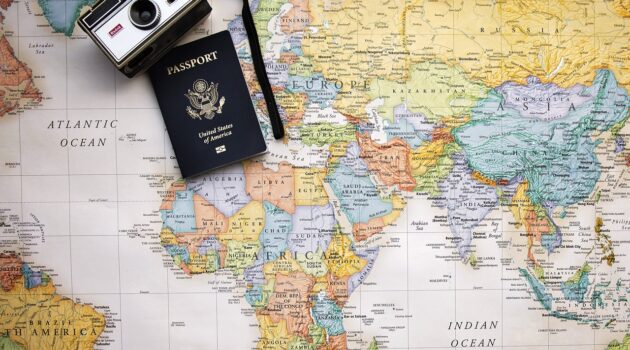 Travel Tips You Need To Avoid A Stressful Vacation - passport travel documents and camera A Full Review: ImmiAssist for Travel Visas