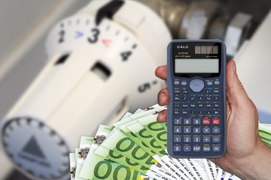 Unexpected Travel Expenses (And How to Avoid Them) - hand with calculator