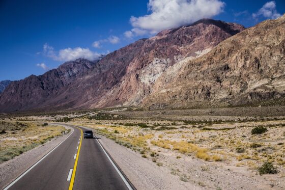 travel without limits Why the Journey Can Be the Best Part of Traveling - road with mountains feeling of adventure