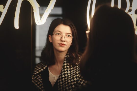 Top Tips to Choose New Glasses - looking in mirroe