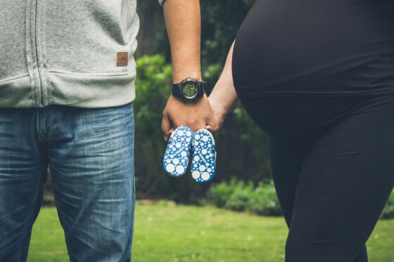 Comfortable Maternity Pants Every Mom Needs for Travel - Family Holding Baby Shoes