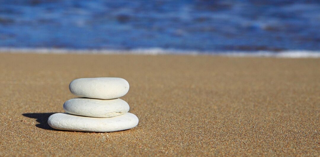Minimalist Living: How Cutting Excess Brings Peace of Mind 4 Minimalist Living How Cutting Excess Brings Peace of Mind - Stacked Rocks on a Beach