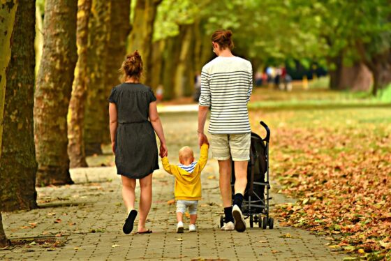5 Ideas for Your 2026 Family Break - Family Holding Hands in Park