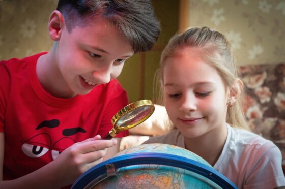 Planning Your Next Family Trip - Kids Looking at a Globe