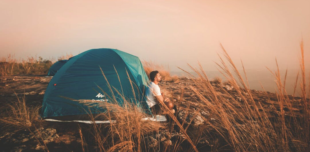 Planning Your Next Trip - Man in Front of Tent