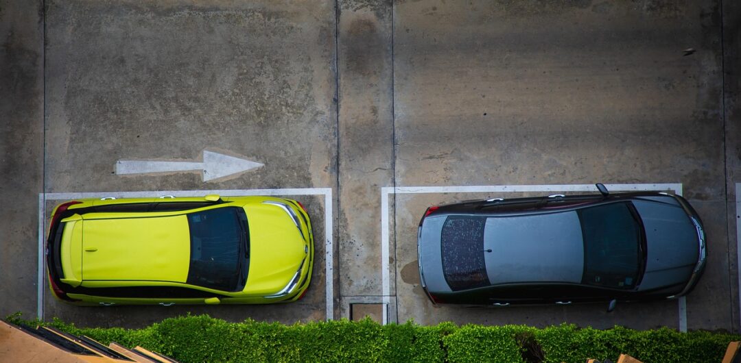 5 Effective Ways to Improve Parking Lot Traffic Flow and Management - Two Cars in Parking Spots