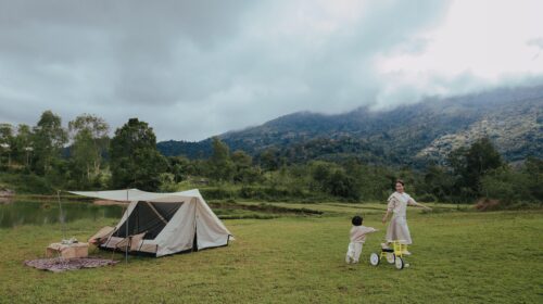 Advice To Ensure Your Next Family Camping Trip Is A Success - Mother and Child Playing by a Tent