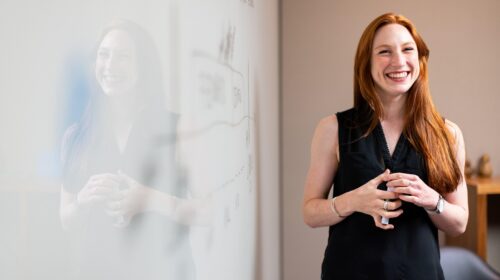 Career Paths That Do Not Require a Traditional Degree - Woman Smiling by Dry Erase Board