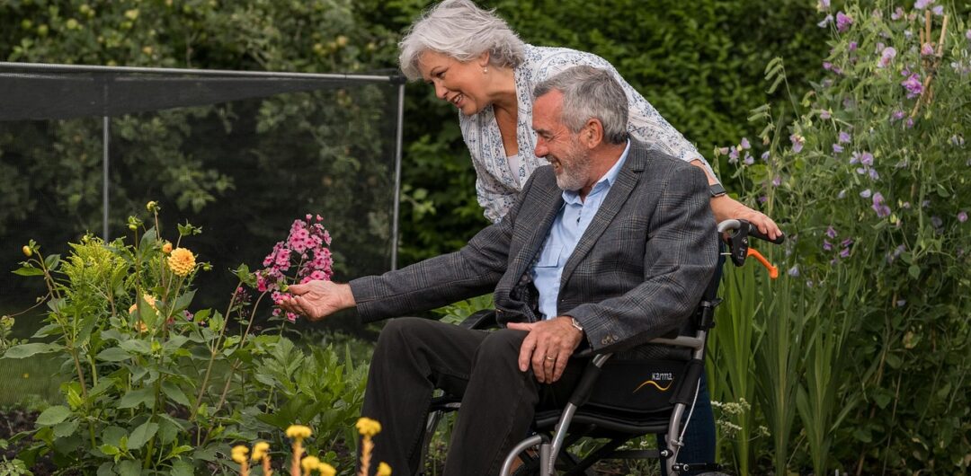 How to Travel with Someone in a Wheelchair? 2 How to Travel with Someone in a Wheelchair - Eldery Couple in a Garden