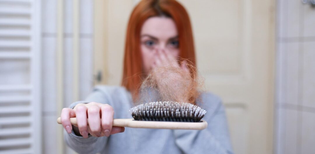 Keep Your Hair On: 7 Ways To Deal With Hair Loss 5 Keep Your Hair On 7 Ways To Deal With Hair Loss - Woman Looking at Hair in Brush