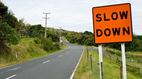 Slow Travel and Rediscovering the Joy of Journey - Slow Down Road Sign