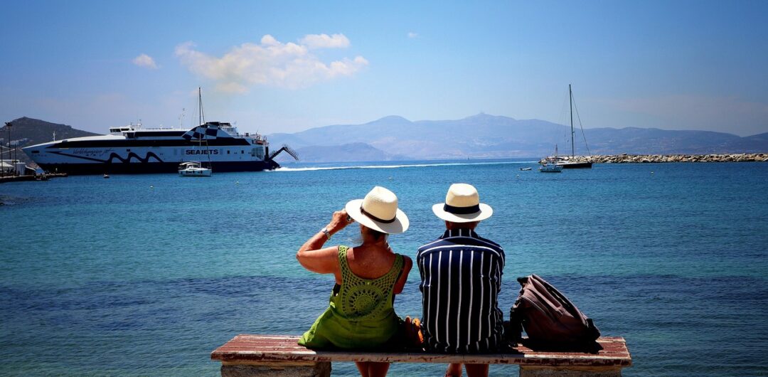 Why You Sometimes Need to Take a Break on Holiday - People Siting on a Bench by Water