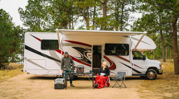 Homepage 5 Looking for a Unique Weekend Break Idea? Here’s Why You Should Consider an RV Trip - Man and Woman Relaxing in Front of RV