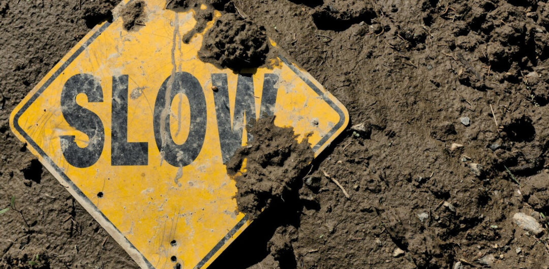 Slow Travel and Rediscovering the Joy of Journey - Slow Sign in Mud