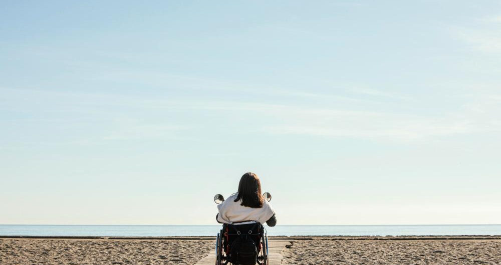 How to Travel with Someone in a Wheelchair? 1 How to Travel with Someone in a Wheelchair - Woman in Wheelchair on the Beach