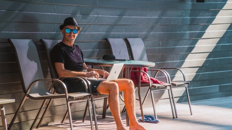 Digital Nomads Read This for Tips on How to Work While Adventuring - Man with a Laptop by a Pool
