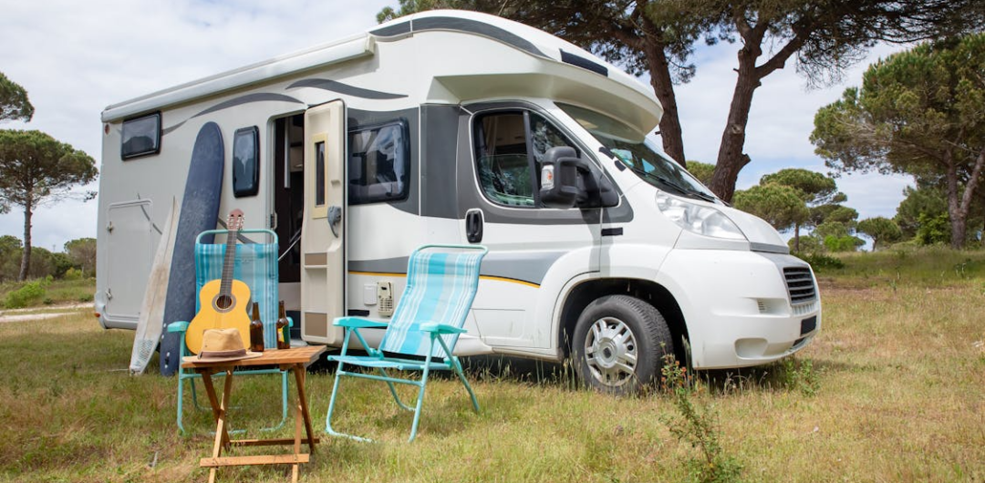 Going on an RV Trip for the First Time? Here's What you Need to Know - RV with Chairs and Guitar